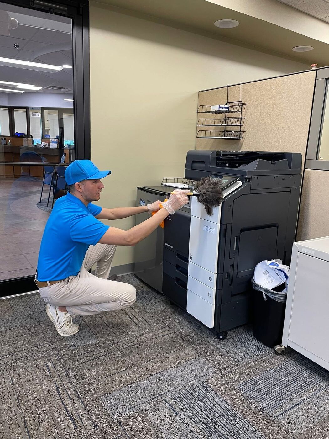 Impact Cleaning crew member detailing office equipment